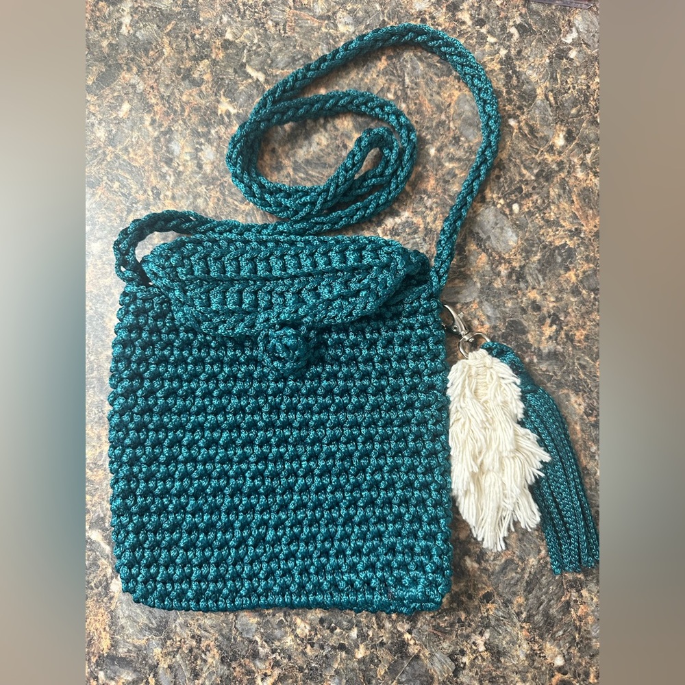 Handmade teal crochet 🧶 crossbody with feather and tassel accents